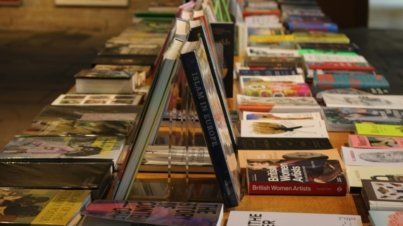 A row of books sitting on top of a wooden table