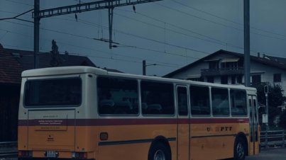 A yellow and white bus parked in a parking lot
