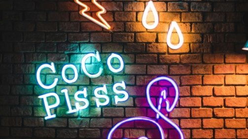 Coco Plsss neon signage hanging on brick wall