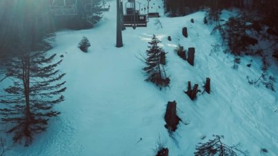 a ski lift going up a snowy hill