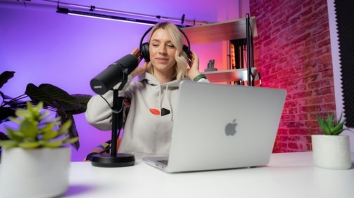a woman sitting in front of a laptop computer