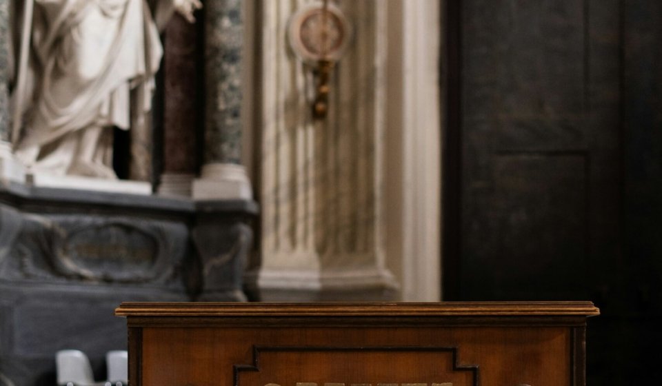 a wooden box sitting in front of a statue