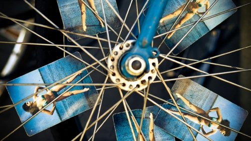 blue and grey bicycle wheel with photo of woman