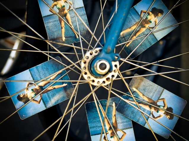 blue and grey bicycle wheel with photo of woman