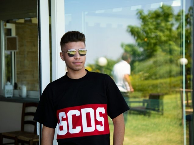 boy in black crew neck t-shirt wearing black framed eyeglasses