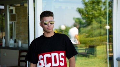 boy in black crew neck t-shirt wearing black framed eyeglasses