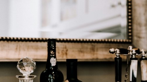 clear glass bottles on brown wooden table