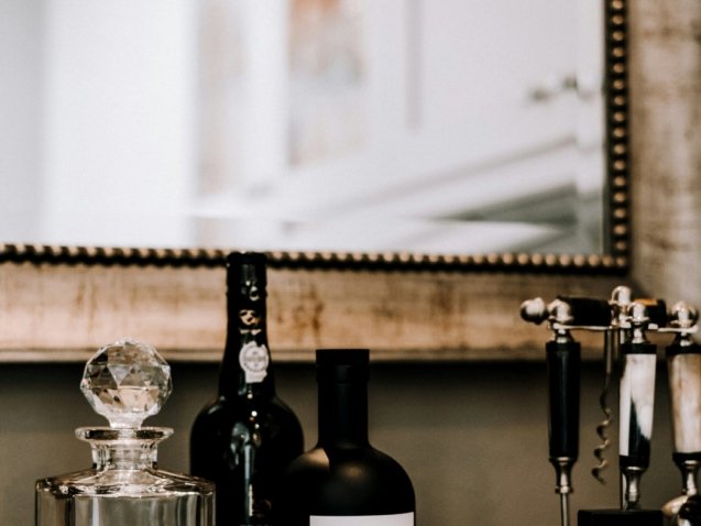 clear glass bottles on brown wooden table