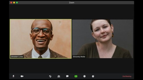 man in black suit jacket smiling
