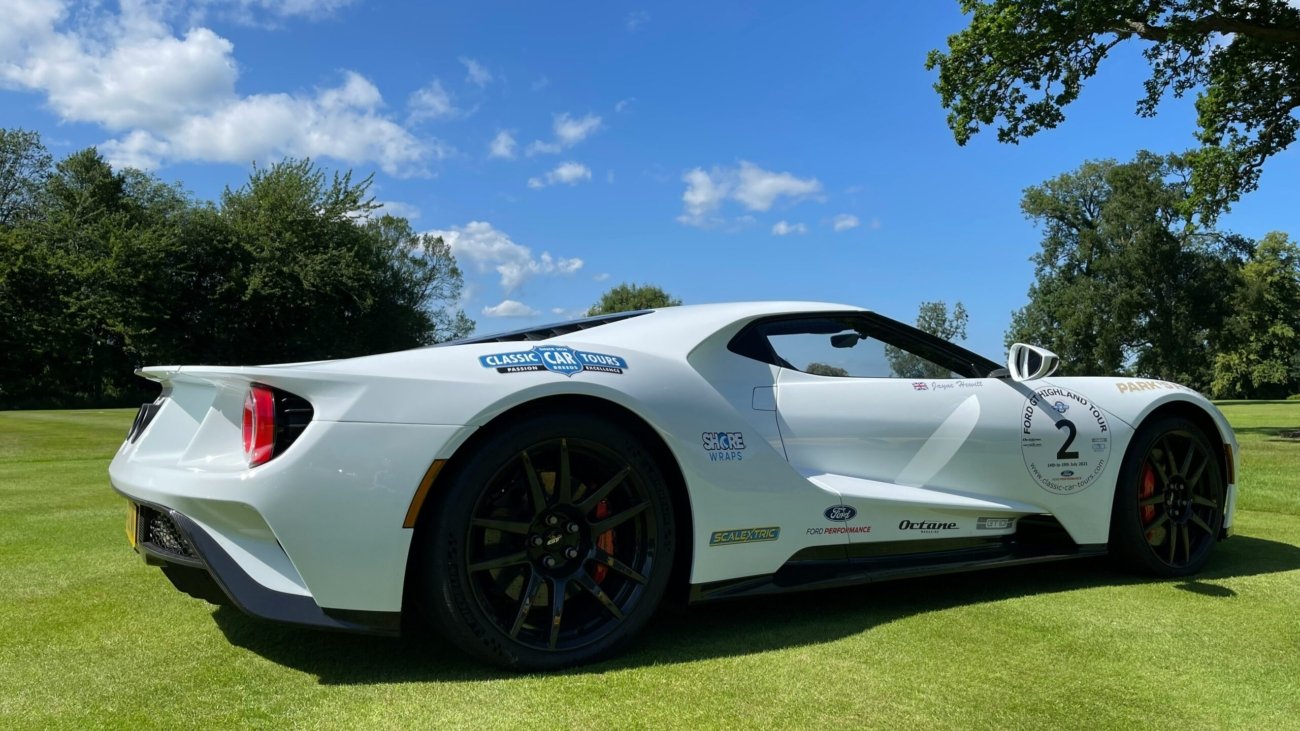 white porsche 911 on green grass field during daytime