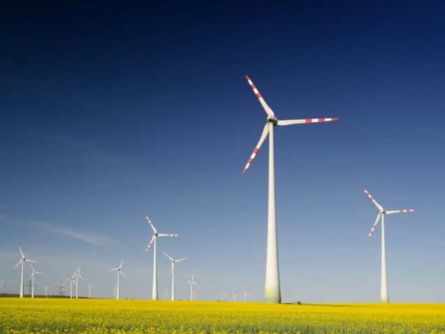 windmills on grass field at daytime
