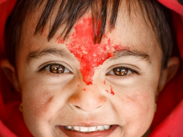 woman in red hijab with white powder on her face